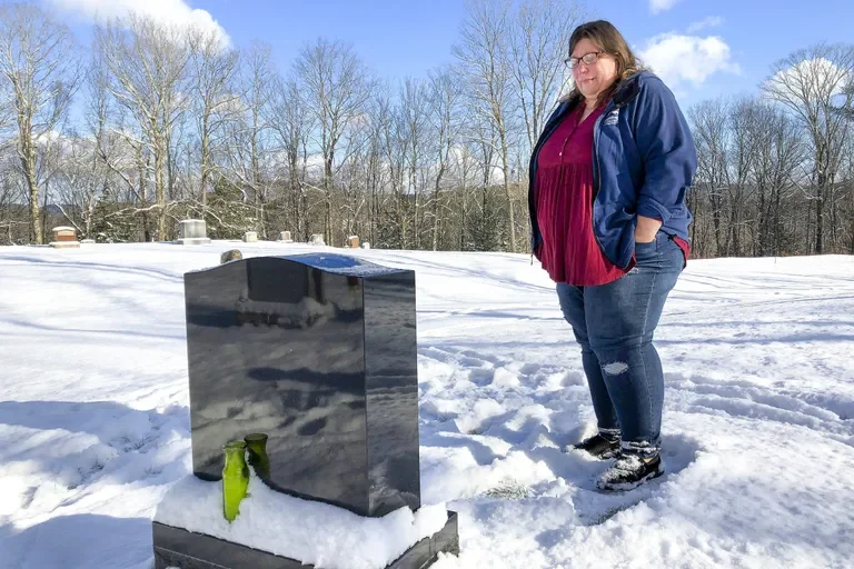 FILE – Deb Walker visits the grave of her daughter, Brooke Goodwin, Thursday, Dec. 9, 2021, in Chester, Vt.